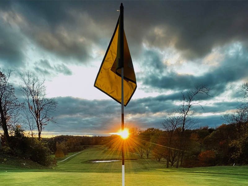 Rocky Ridge Golf Club sun peeking behind a golf flag